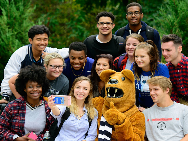 Group of students taking a picture with the Nittany Lion mascot 