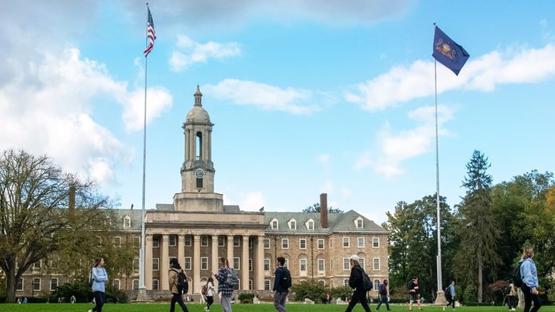 Exterior photo of Old Main with students walking on the sidewalk