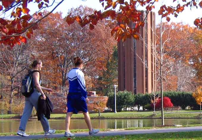 Photo of Penn State Altoona students walking past the duck pond by the chapel, on campus.