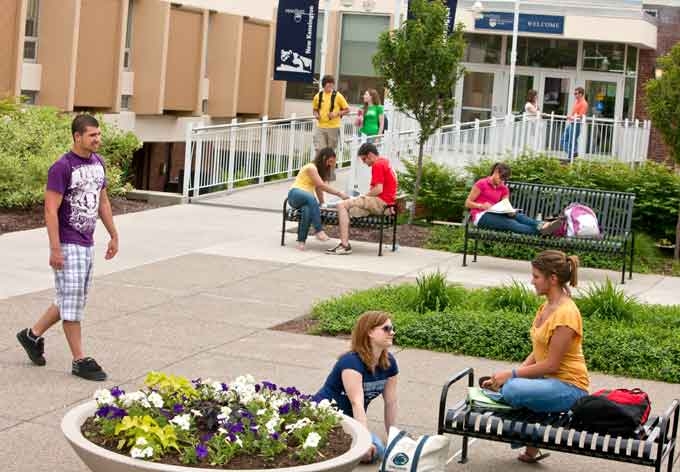 Students featured on the courtyard, outside the main entrance of the classroom building.